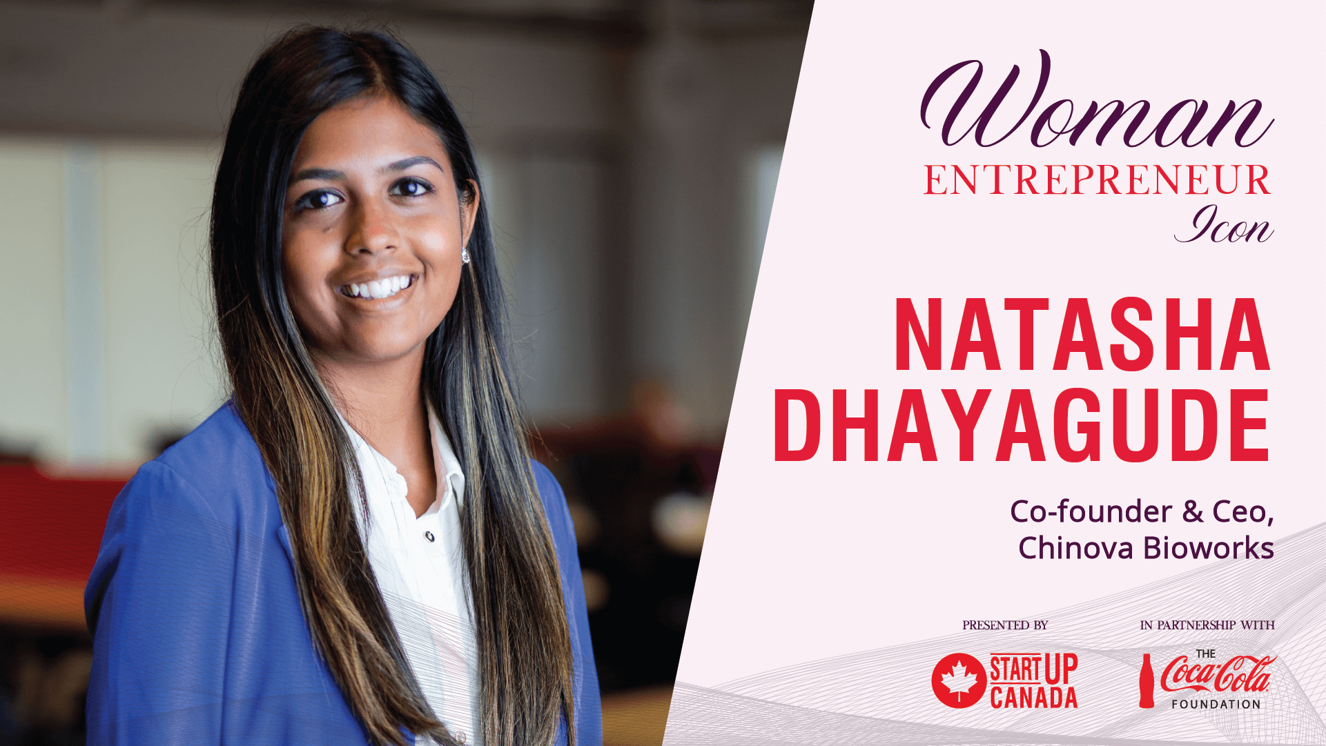 Photo of a young woman with dark skin wearing a blue blazer smiling.