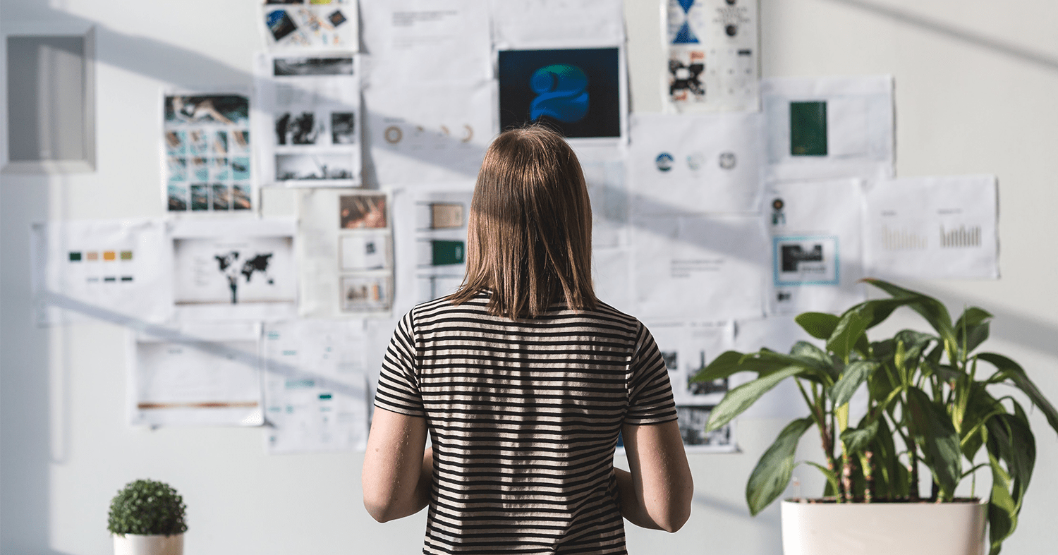 A person stands in front of a wall of information on how to export as an entrepreneur.