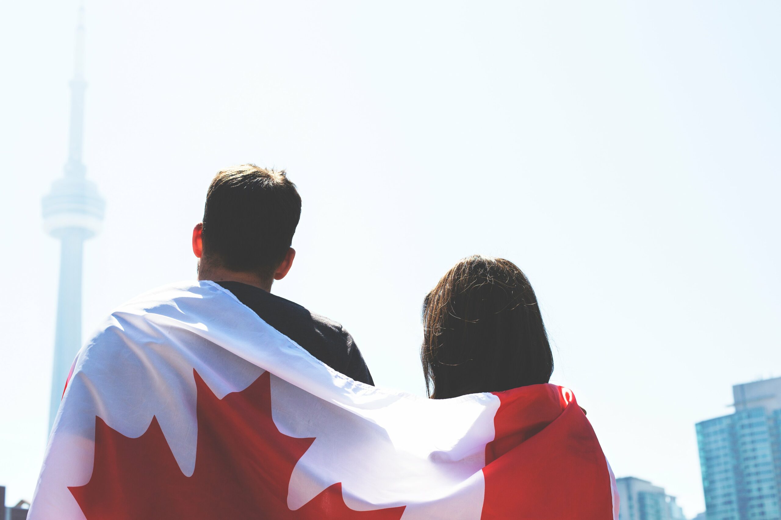 Canadian entrepreneurs with a Canadian flag wrapped around them