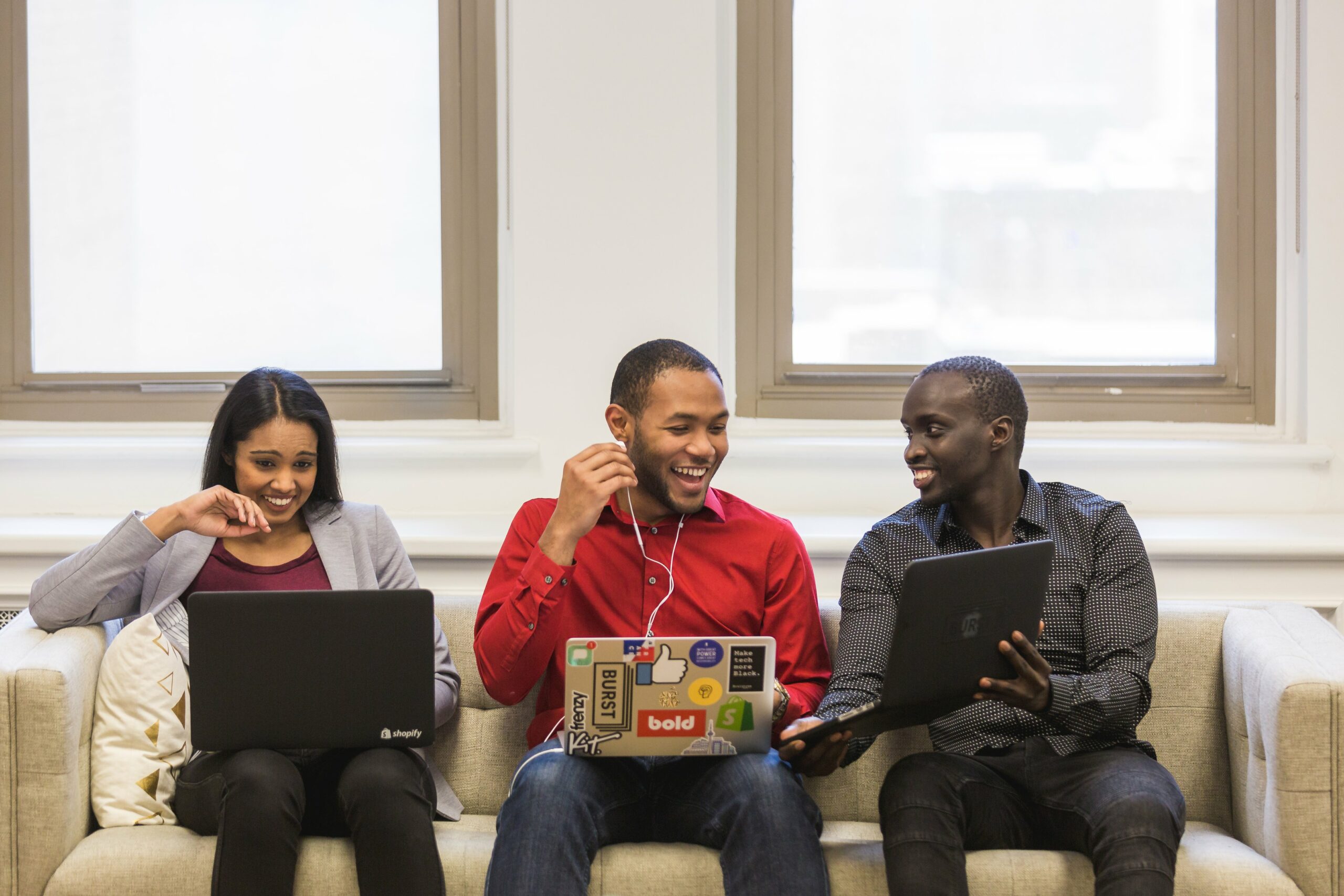 Canadian entrepreneurs sitting on a couch and laughing