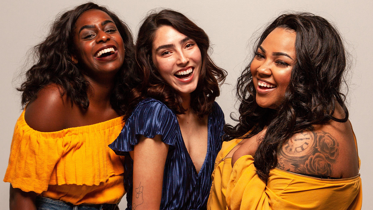 Three women smiling and laughing to launch Startup Women 2022