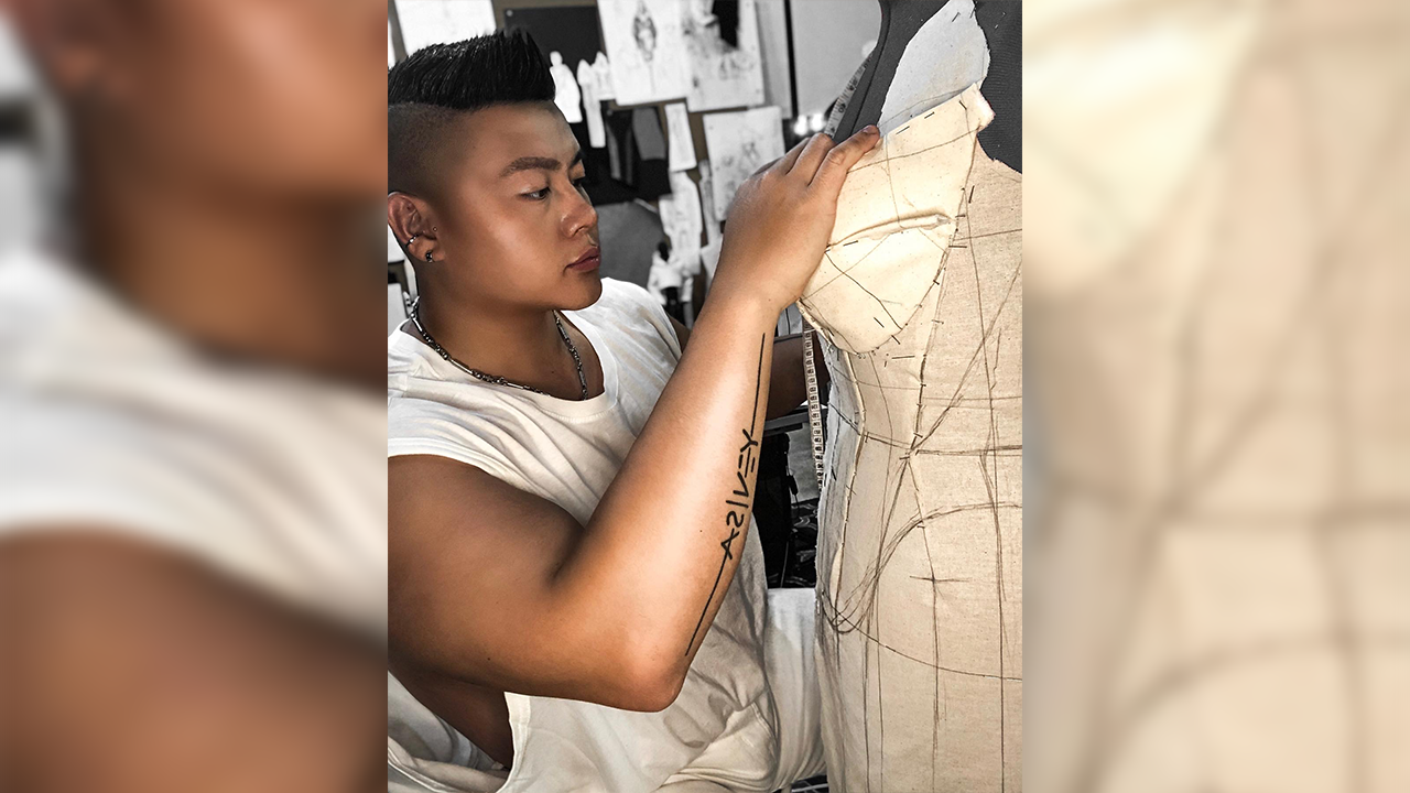 Charles Lu attaching his design to a mannequin.